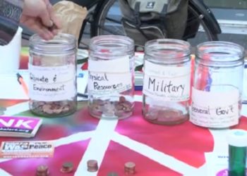 Protestors Rally Outside Eugene Public Library on Tax Day to Challenge Military Spending