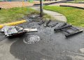 Astoria Parks crews clean up damaged trash can after holiday celebrations at Fred Lindstrom Park