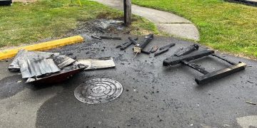 Astoria Parks crews clean up damaged trash can after holiday celebrations at Fred Lindstrom Park